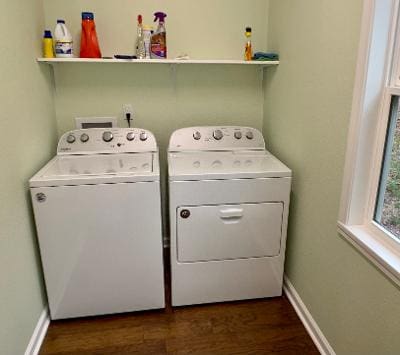 Two washers and dryers in a small room.