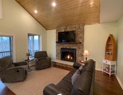 A living room with a fireplace and a flat screen tv.