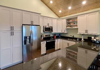 A kitchen with white cabinets and stainless steel appliances.