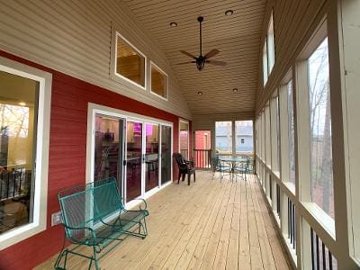 A screened in porch with a table and chairs.