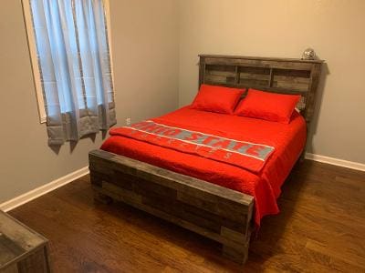 A bed or beds in a room at a house in the woods.