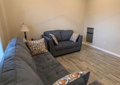 A living room with couches and a fireplace.