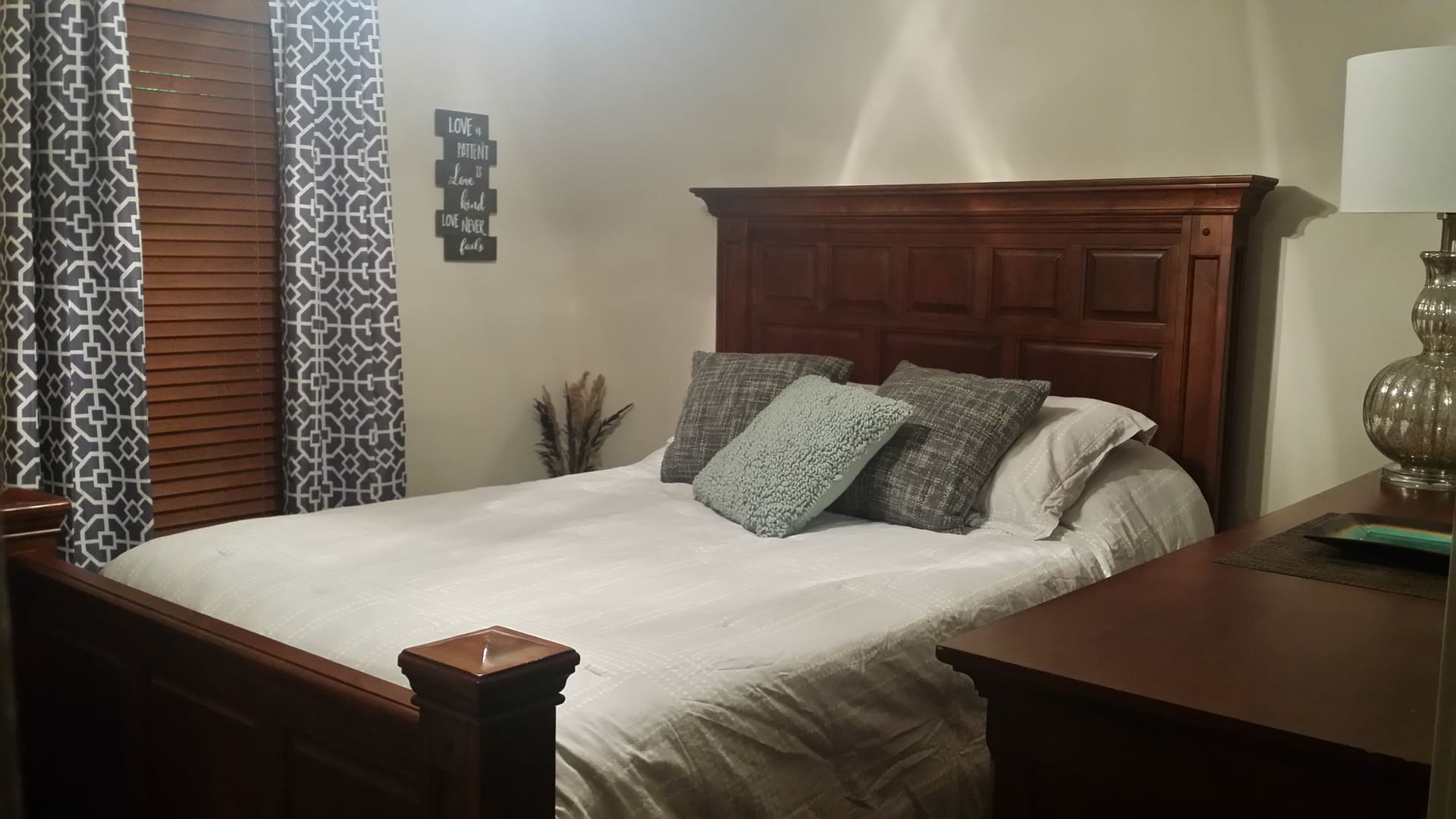 A bedroom with a bed and a dresser.