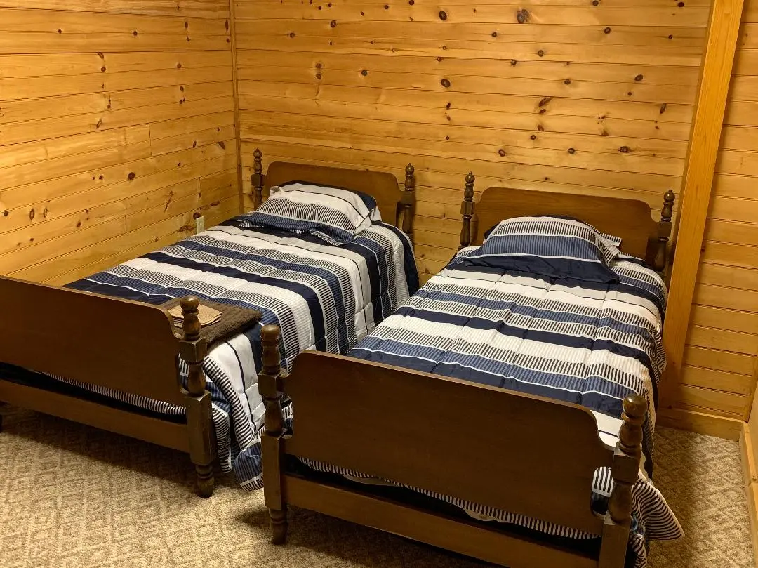 Two twin beds in a cabin room.