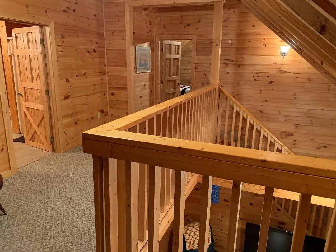 A view of a cabin with stairs and a couch.