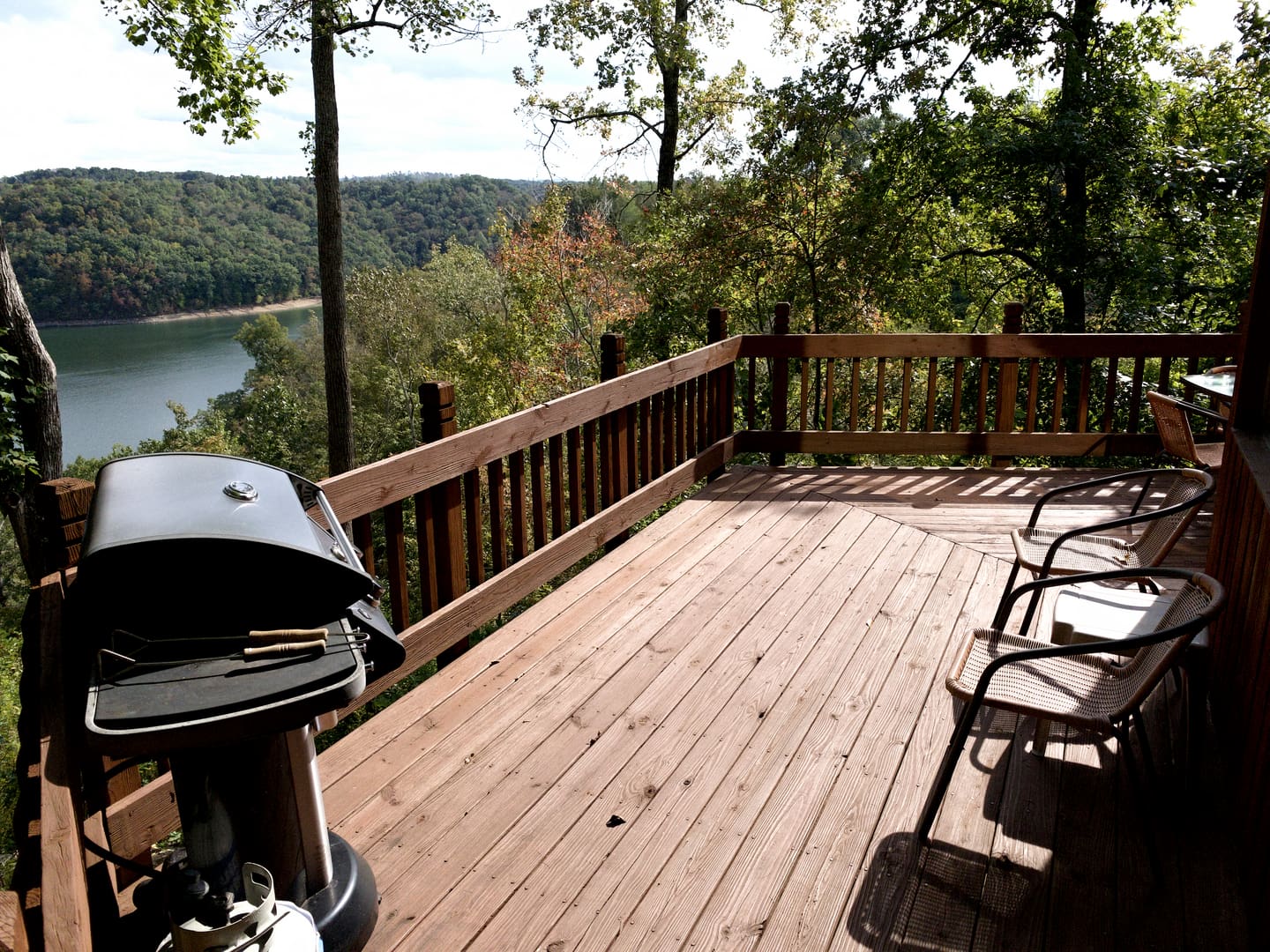 A wooden deck overlooking a lake.