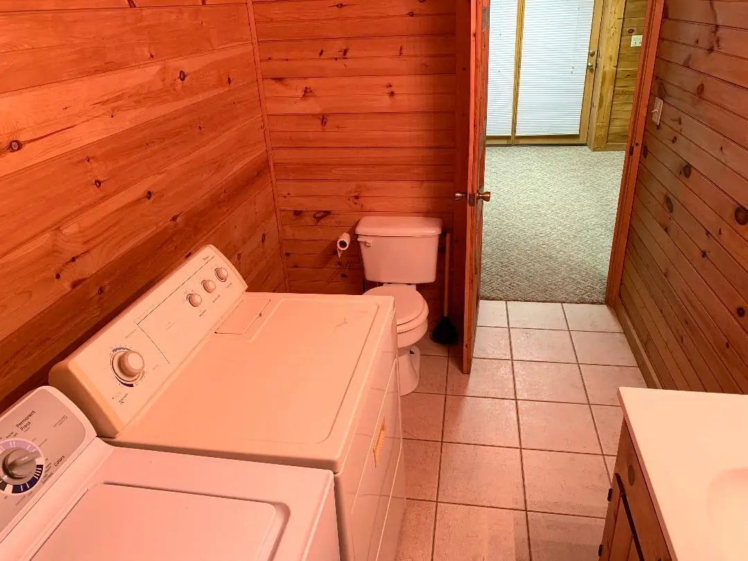 A bathroom with a washer and dryer.