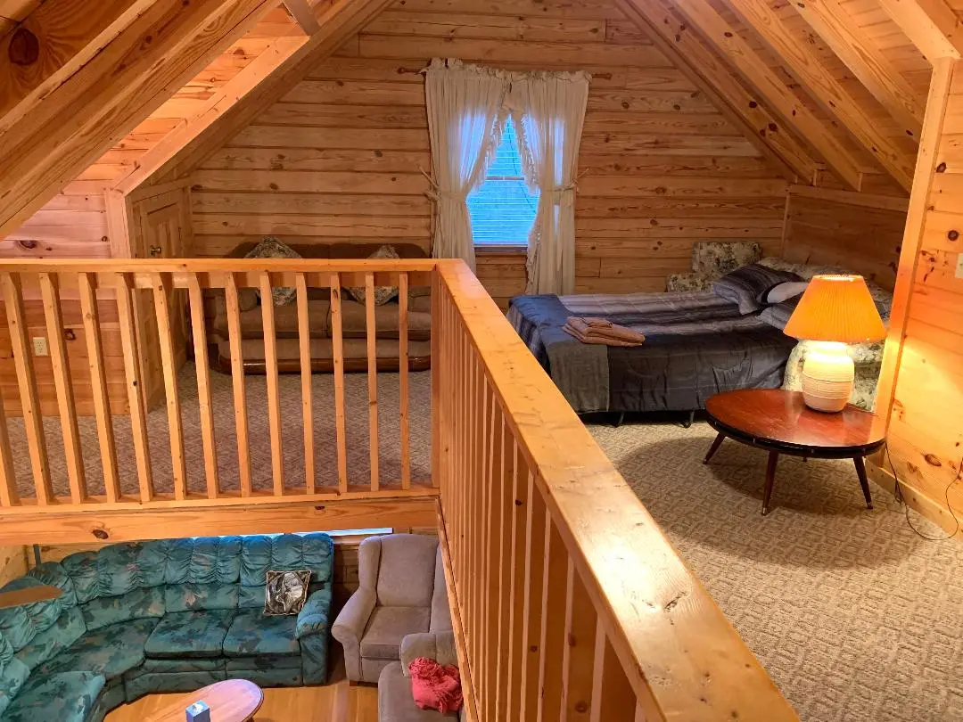 A view of a bedroom in a log cabin.