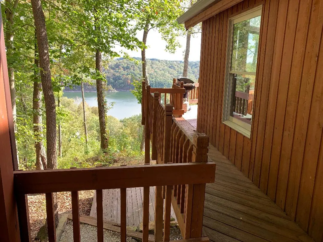 A view from the deck of a cabin overlooking a lake.