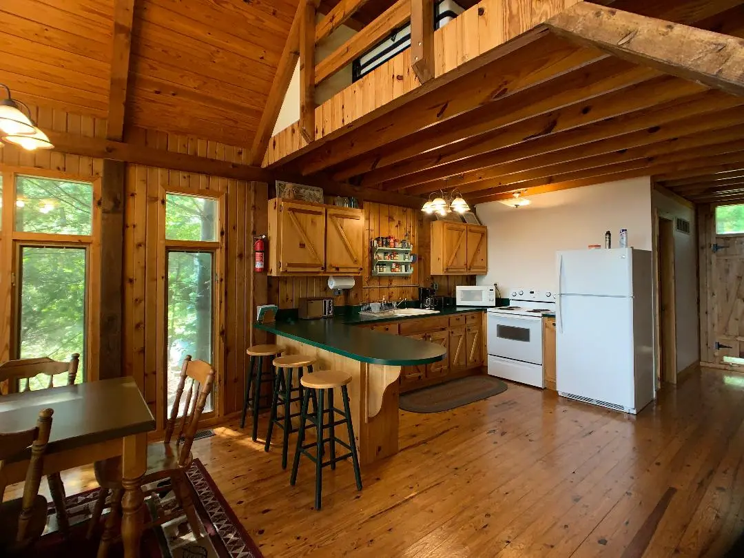 A kitchen and dining area in a log cabin.