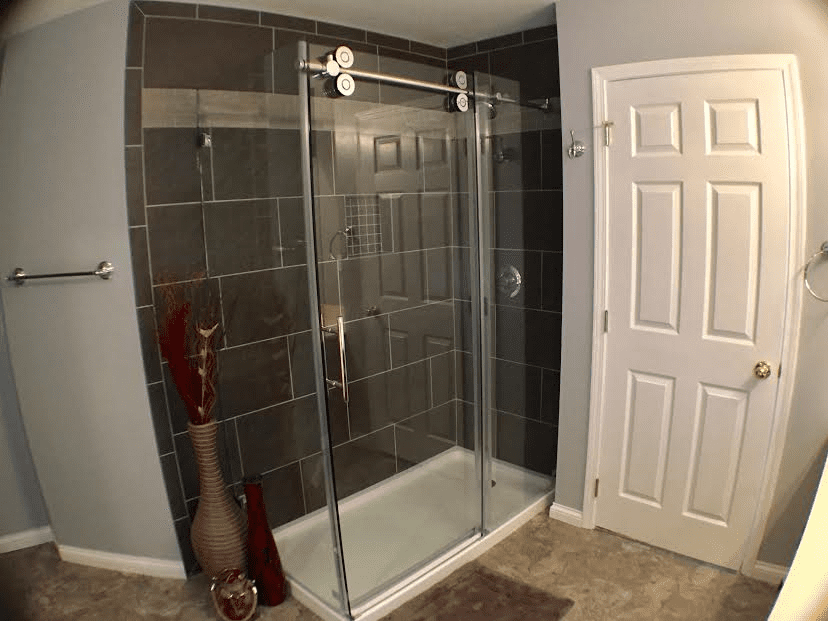 A bathroom with a glass shower door.