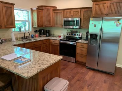 A kitchen with wooden cabinets and granite counter tops.