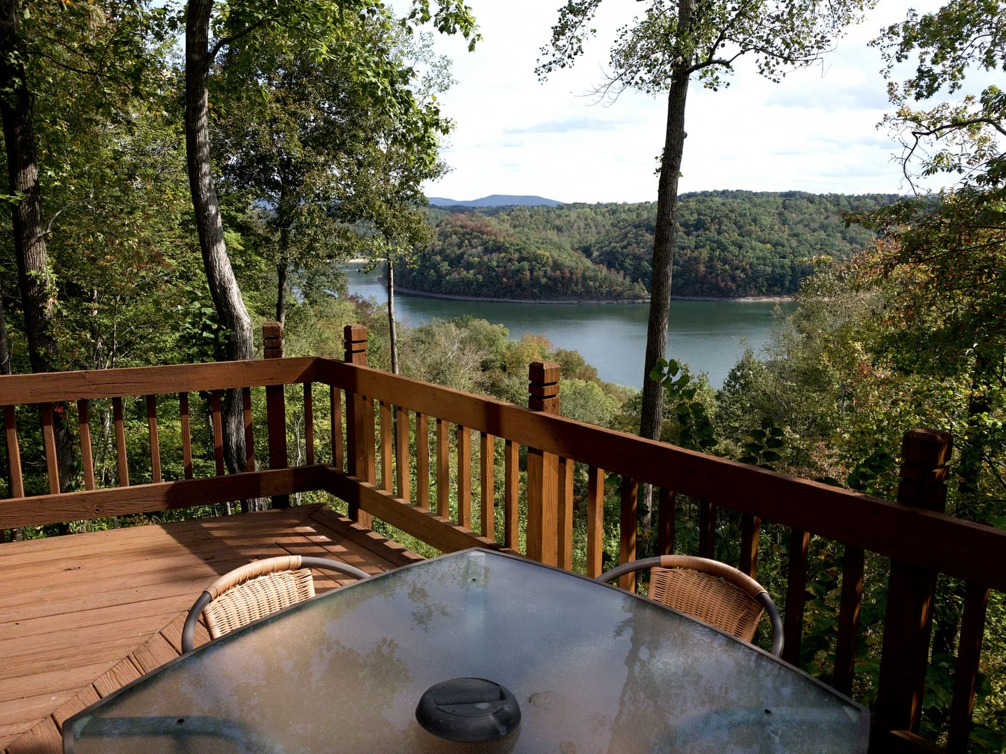 A wooden deck with a view of a lake.