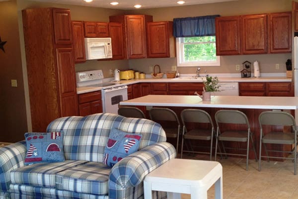 A kitchen with a table and chairs.