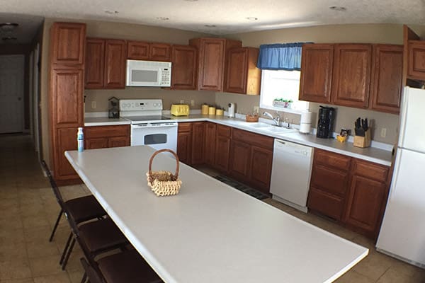 A kitchen with a white counter top.