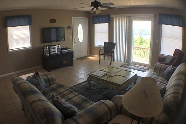 A living room with couches and a tv.