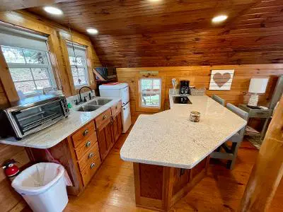 A kitchen or kitchenette in a log cabin.