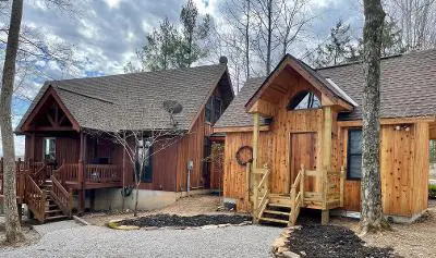 The building where the cabin is located is in the woods.