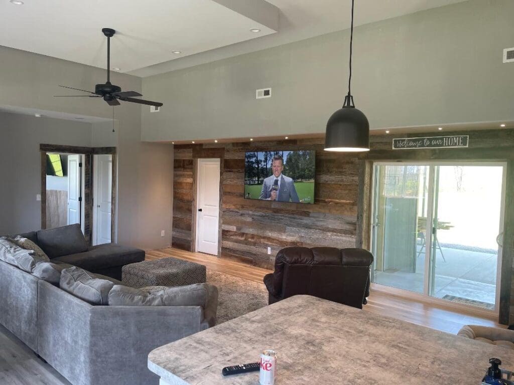 A living room with a tv on the wall.