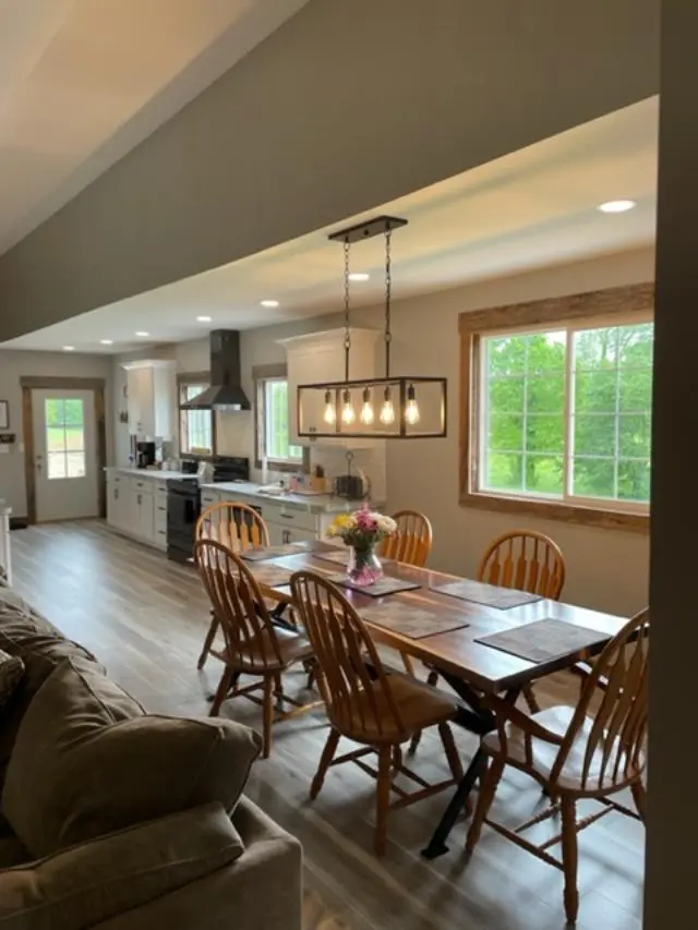 A living room with a dining table and chairs.