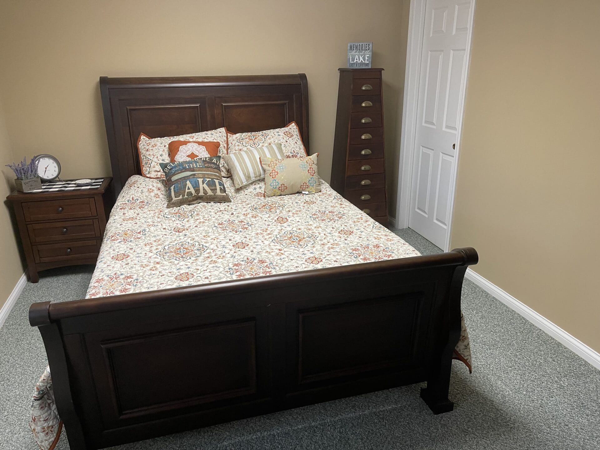 A small bedroom with a bed and dresser.