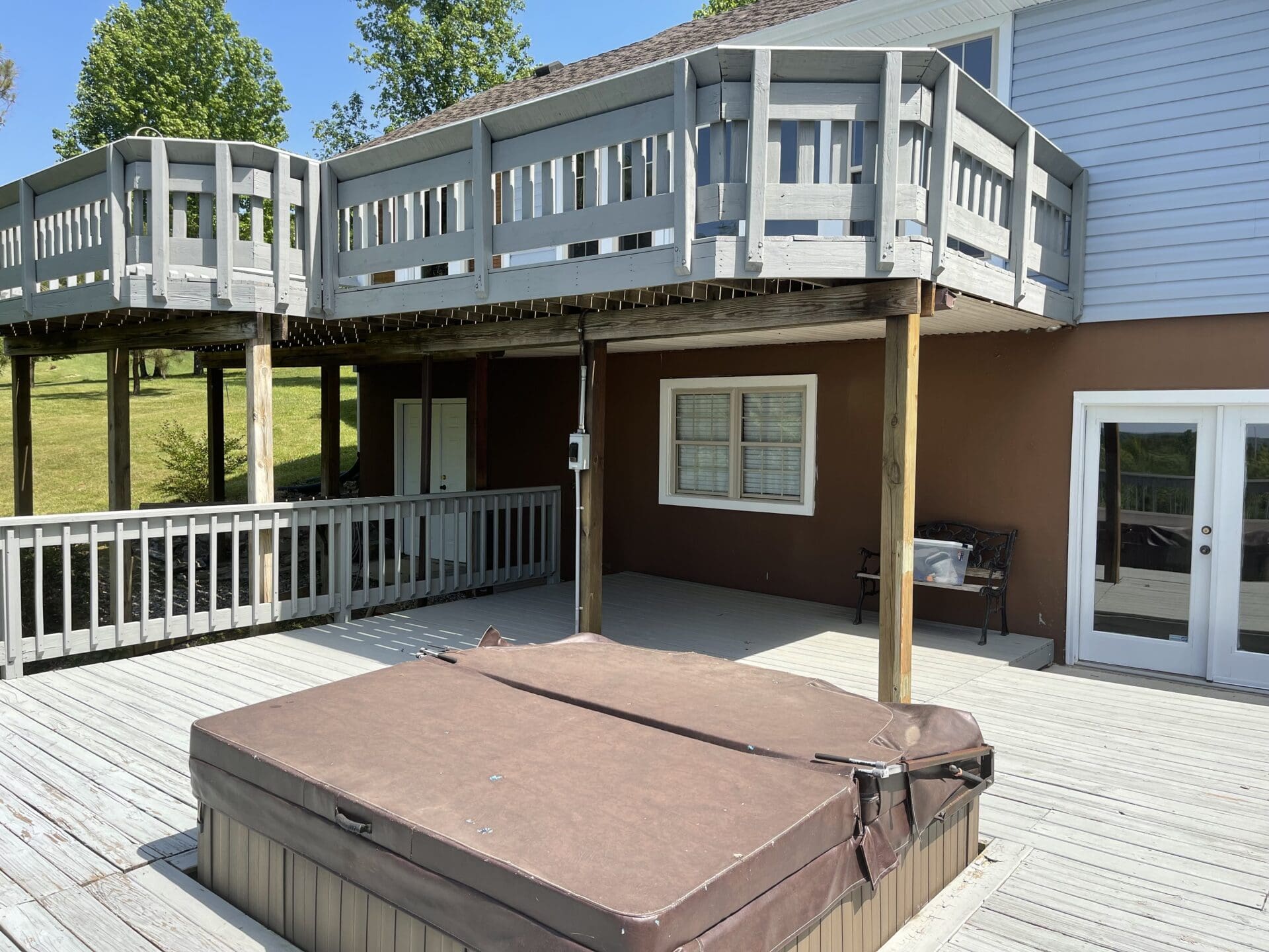 A hot tub on the deck of a house.