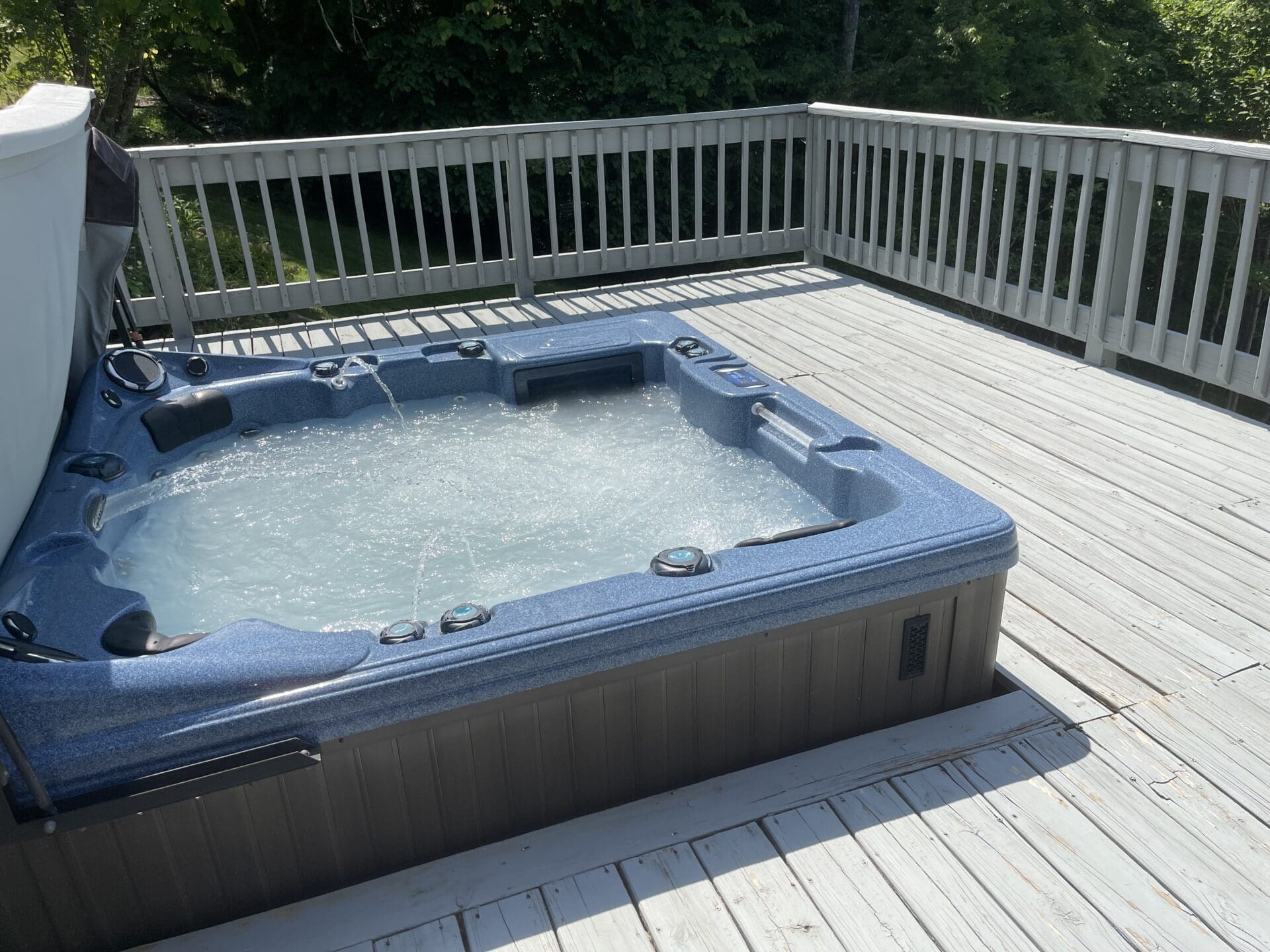 A hot tub on the deck of a home.