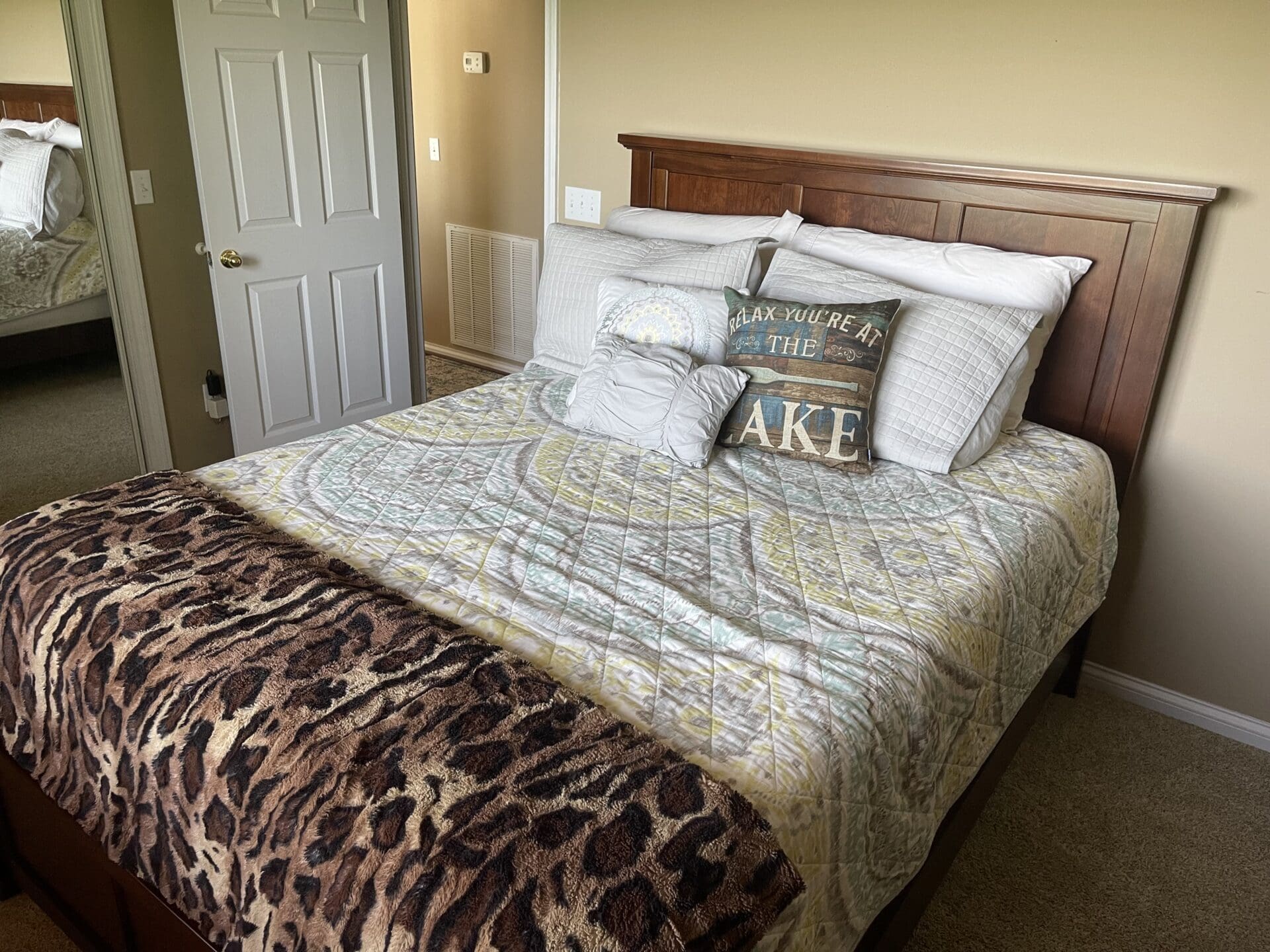 A bed with a leopard print comforter.