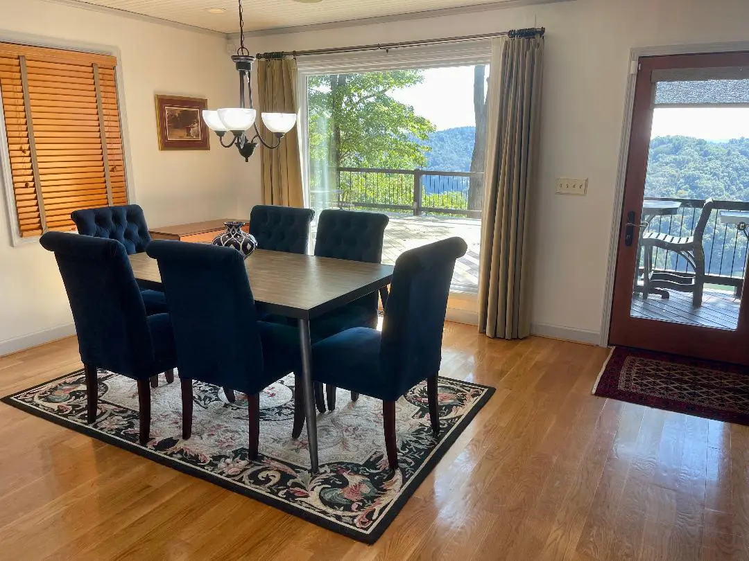 A dining room with hardwood floors and a view of the mountains.