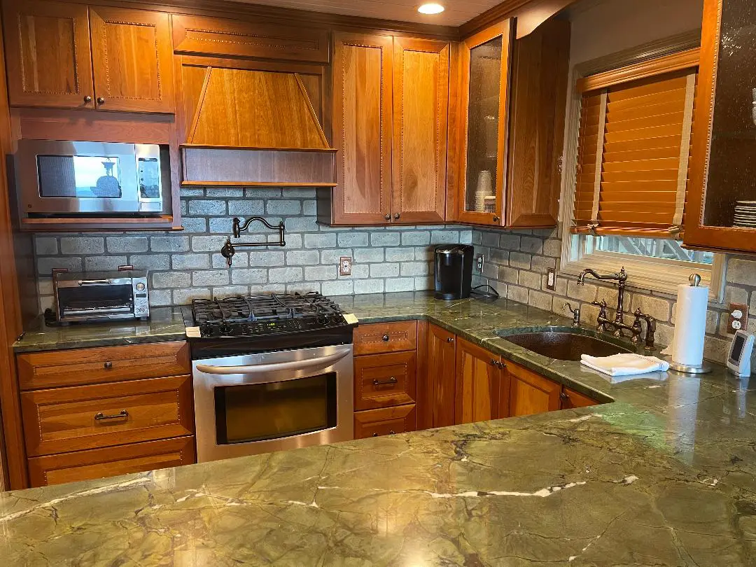 A kitchen with wood cabinets and granite counter tops.