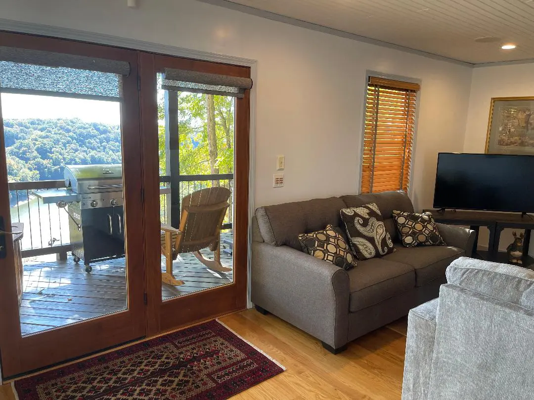 A living room with a sliding glass door and a couch.