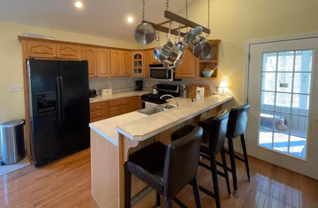 A kitchen with stools and a counter top.