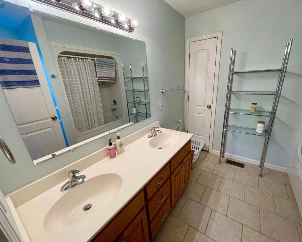 A bathroom with two sinks and a mirror.