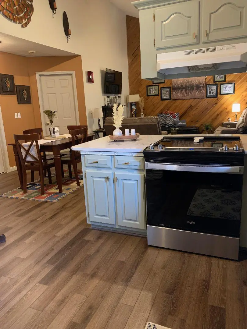 A kitchen with wood floors and a stove.