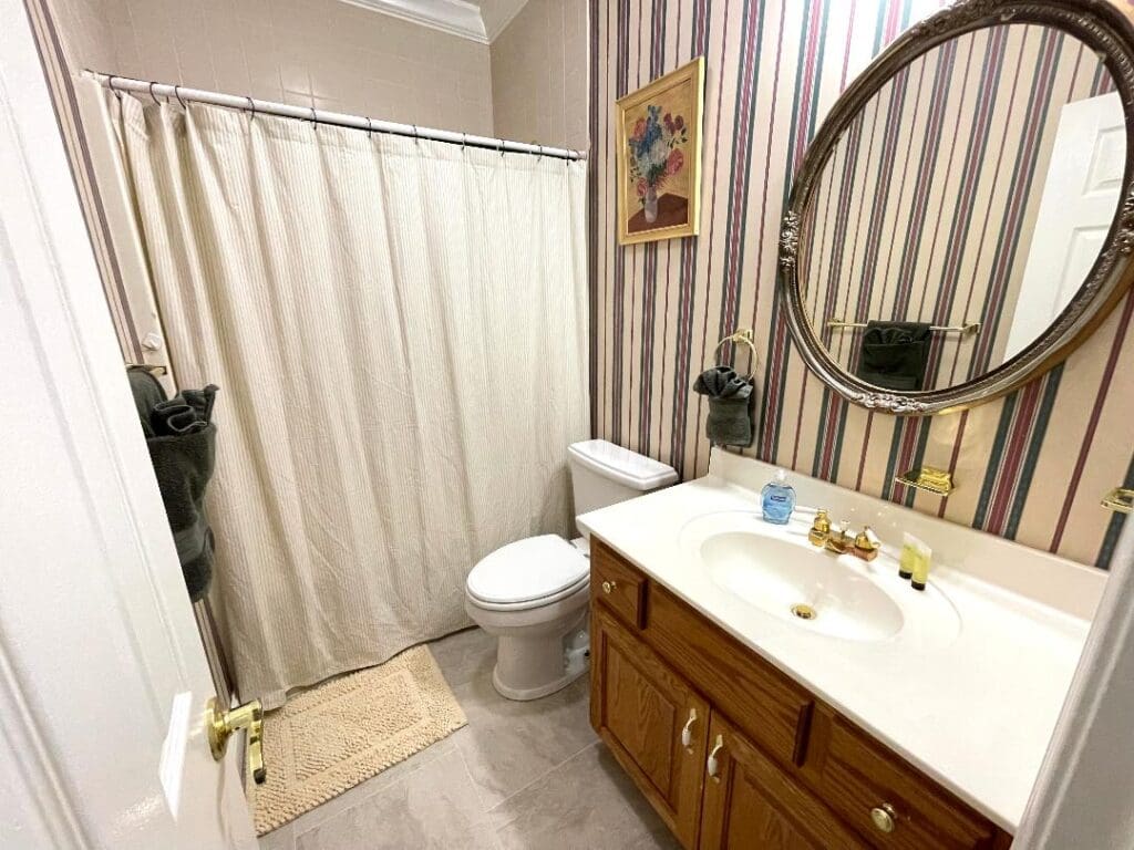 Bathroom with shower, sink, and toilet.