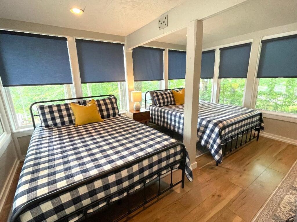 Bedroom with two checkered beds, blue shades.