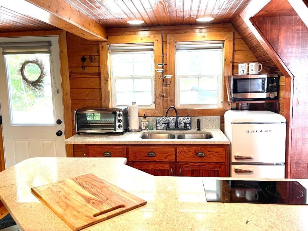 Rustic kitchen with wooden cabinets and appliances.