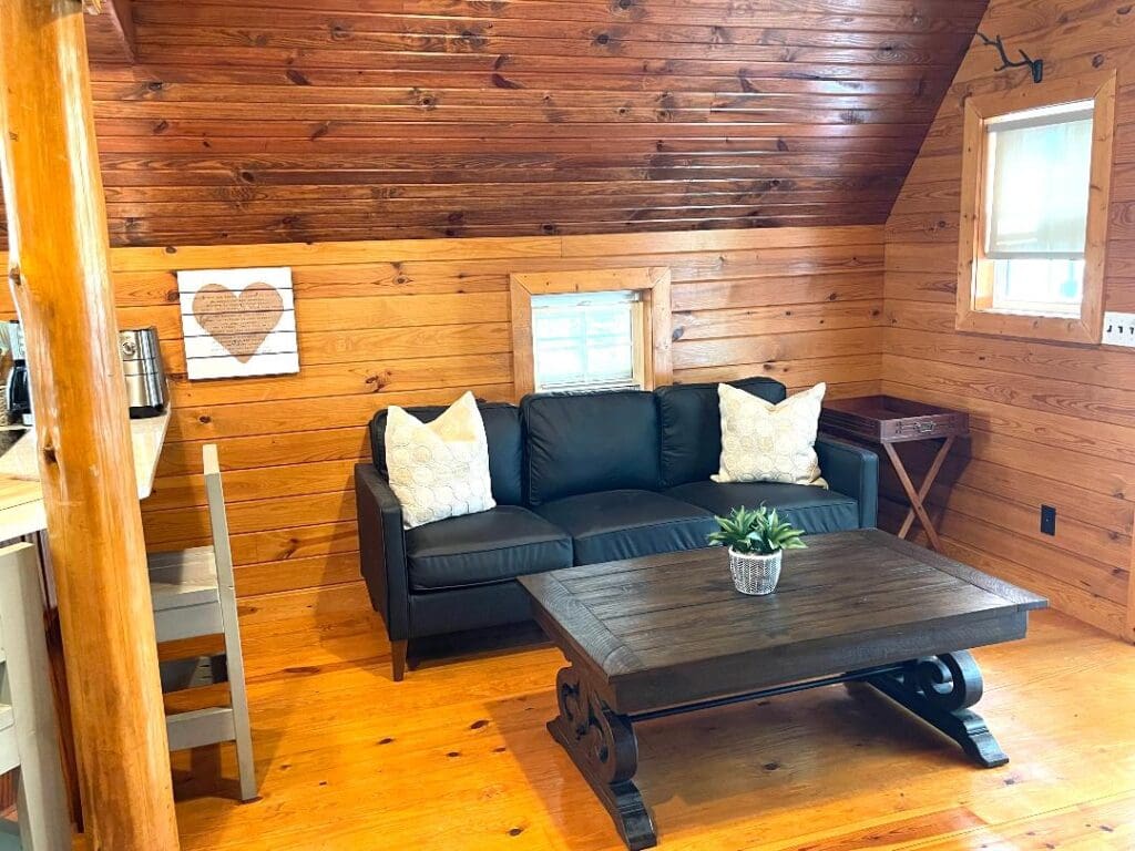 Cozy wooden cabin living room with sofa.