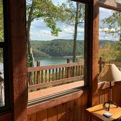 A living room with a view of a lake.