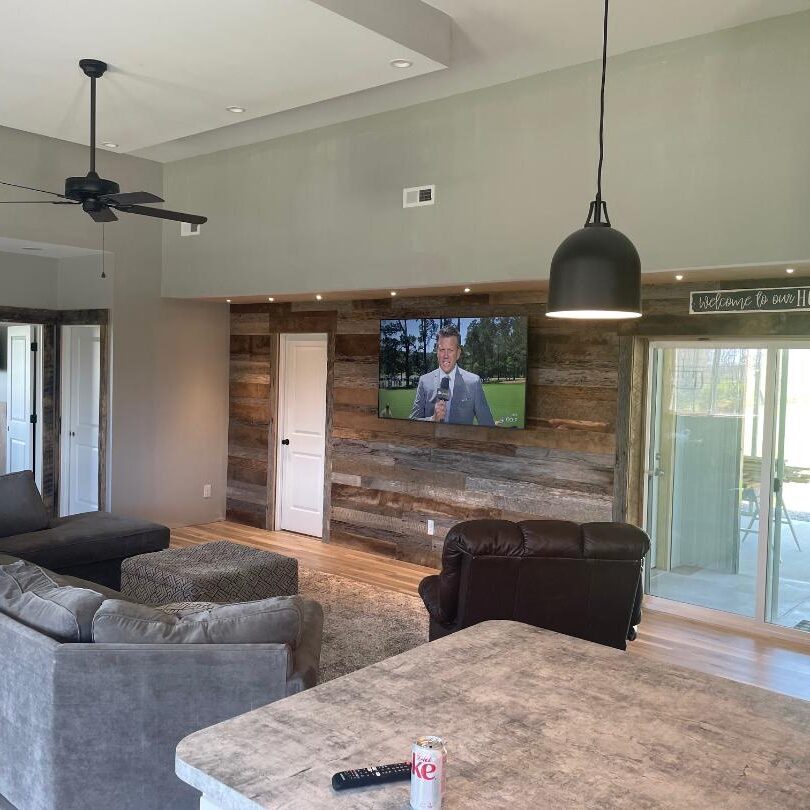 A living room with a tv on the wall.